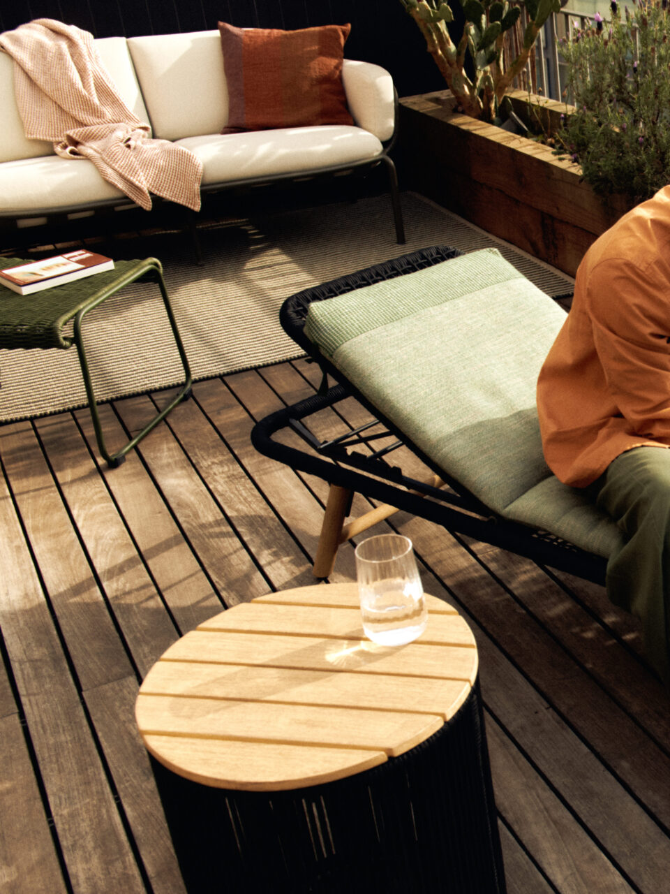 A range of outdoor furniture, including a couch, sun lounger, and side table